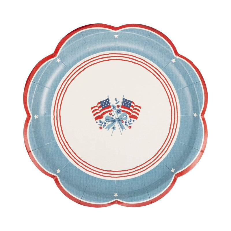Single American flag scalloped paper plate showing full heritage illustration — crossed flags, blue floral ribbon, chambray border, white stars, and red scalloped rim on white background