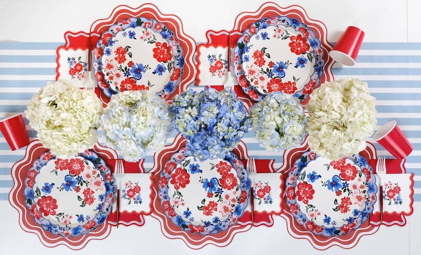 Full table layout featuring Summer Floral Paper Plates styled with red wavy placemats and white hydrangeas.