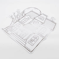 Angled studio shot of the die-cut haunted house placemat highlighting the metallic gunmetal foil shine reflecting light.