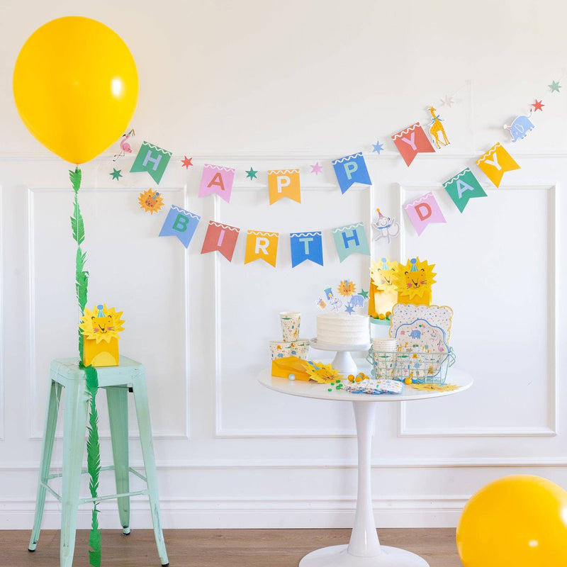 Animal birthday banner displayed above party table with matching decorations and balloon.