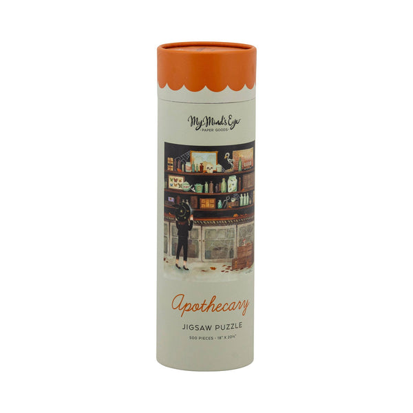 Apothecary Halloween jigsaw puzzle tube showing a witch reaching for a bottle in a shop full of potion jars, skull and cobwebs