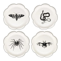 Set of four 8-inch dessert plates—snake, bat, spider, and moth illustrations on cream background with fine black trim.