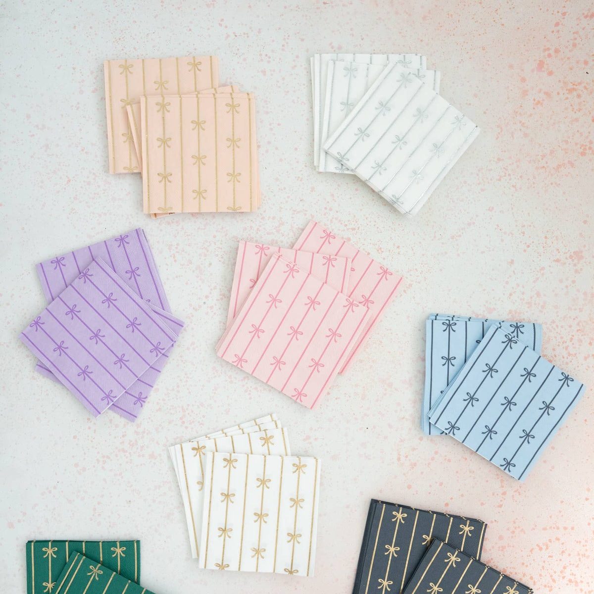 Assorted pastel bow napkins in multiple colors arranged on tabletop