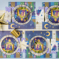 Overhead tablescape with nativity plates, gold flatware, and star accents