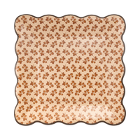 Cream square paper plate with a brown floral block-print pattern and a wavy brown edge, front view.