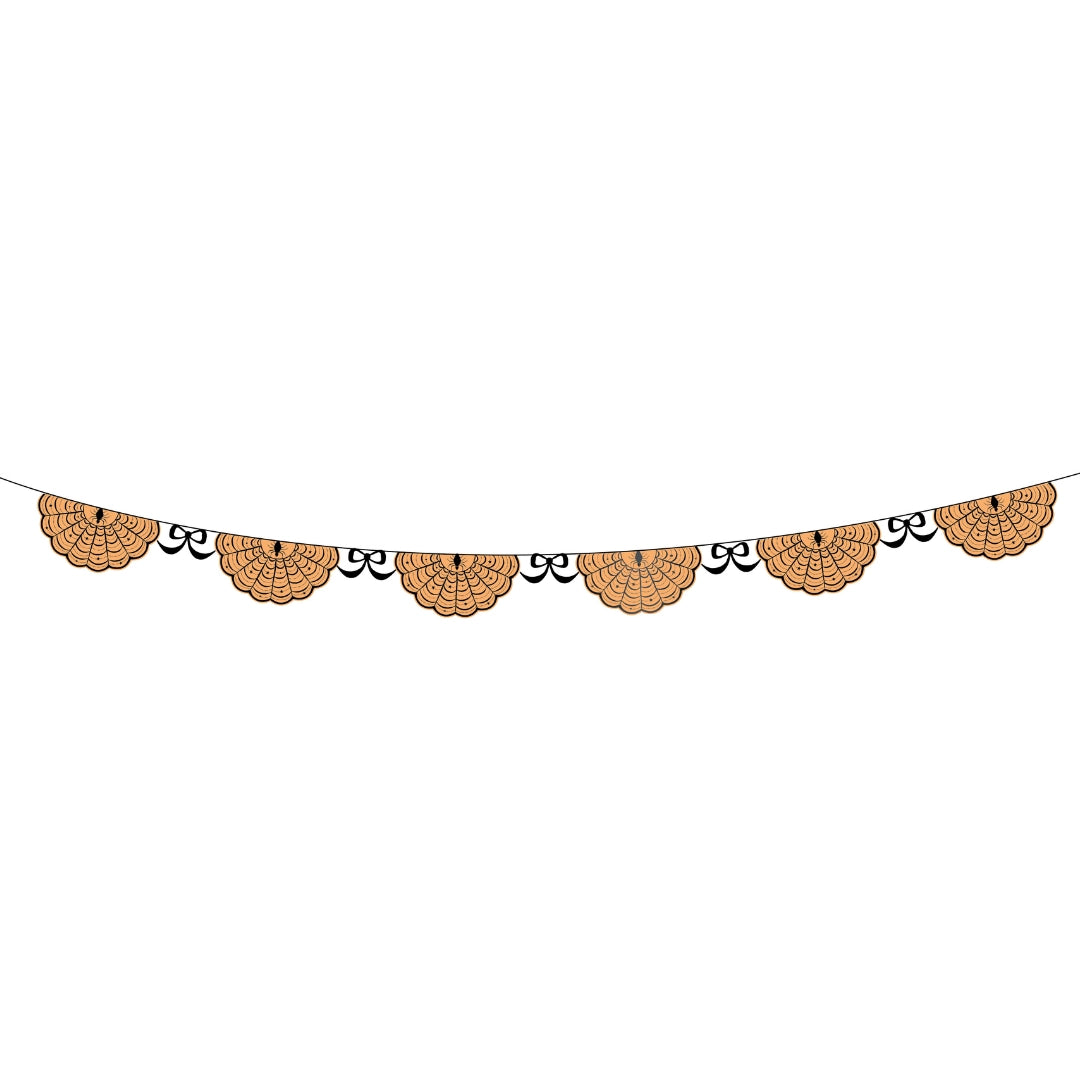 Orange spider web paper banner strung with die-cut webs and small black bow ties between each one