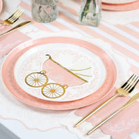 Pink scalloped napkin paired with carriage plate and gold cutlery