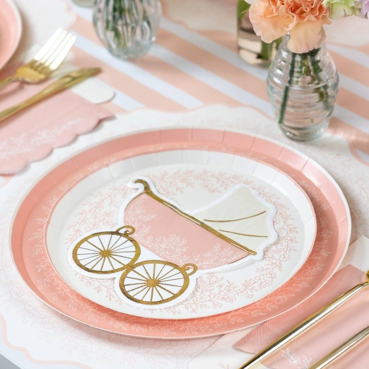 Pink floral plate styled for baby shower table setting