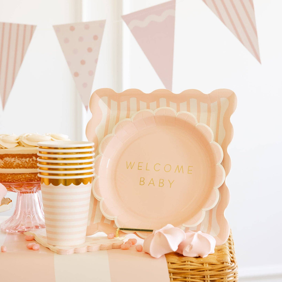 Close up of scalloped pink plate with gold foil lettering