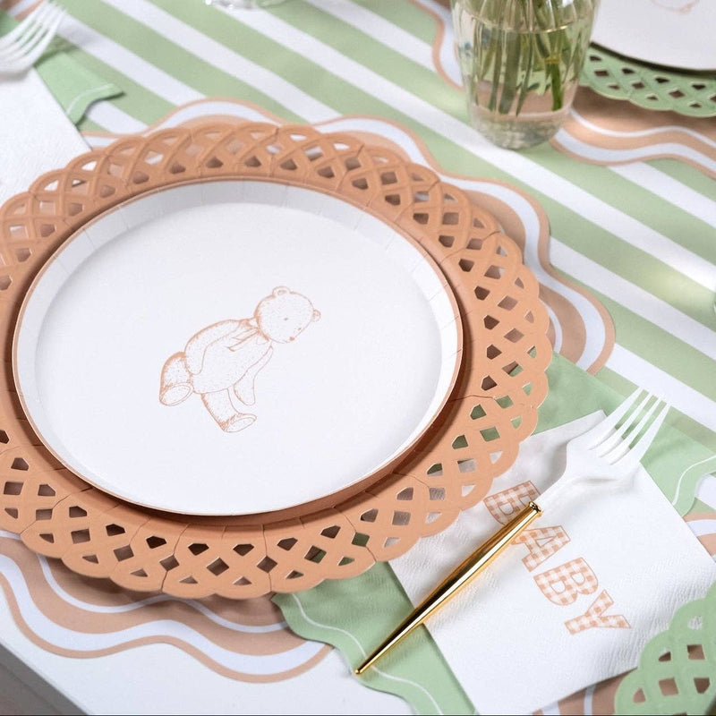 Styled baby shower place setting showing the sage napkin with a bunny plate on a tan scalloped charger and green-striped runner.
