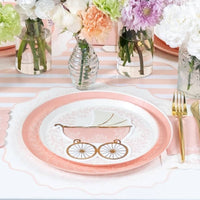 pink baby carriage napkin styled on table setting with plates
