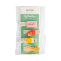 Front of back to school hair barrette set in packaging showing four clips — pink eraser, red YAY megaphone, yellow pencil, and yellow ruler bow — on cream velvet bases