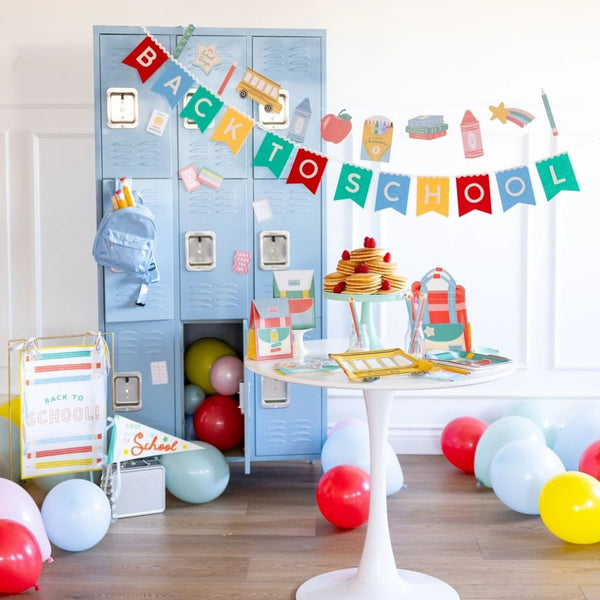 Back to school party setup with banner, balloons, and classroom decor.