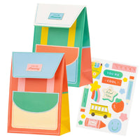 Backpack-shaped treat bags in colorful school-themed design with flap closure.