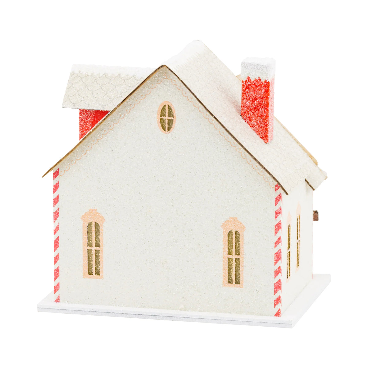 Back view of the Christmas putz house showing the snowy roof, red chimneys, and glittery wall texture.