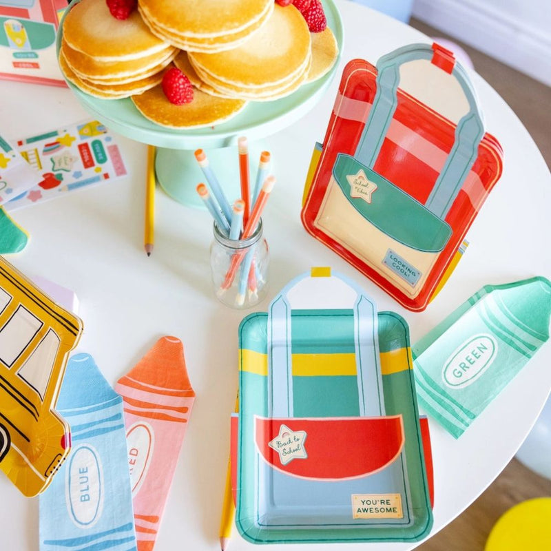 Backpack plate set displayed with back to school party setup.