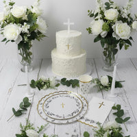 baptism cake table with eucalyptus plates and floral setup