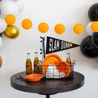 Basketball puffy felt banner displayed above a sports party table with basketball plates and decorations