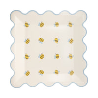 A square paper plate with a blue scalloped rim and a Honey hued palette bee pattern.