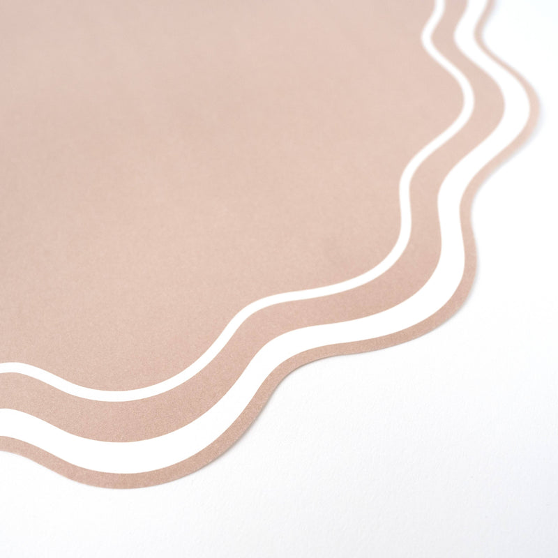 close up of beige wavy scalloped paper placemat edge detail
