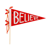 Believe felt pennant flag in red with white lettering, star details, and ribbon trim on wooden dowel.