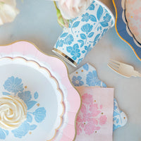 Close-up place setting with Belle Blue dessert plate, matching cup, and floral napkins—periwinkle blue floral plates.