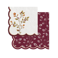 Berry sprig napkin with a burgundy scalloped edge layered over a burgundy leaf print napkin