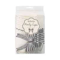 Front packaging of black and white bow party cups showing included cups and bow stickers