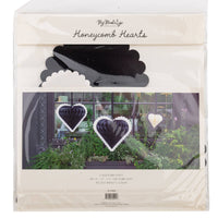 Back view of black and white honeycomb hanging hearts set of three in original packaging