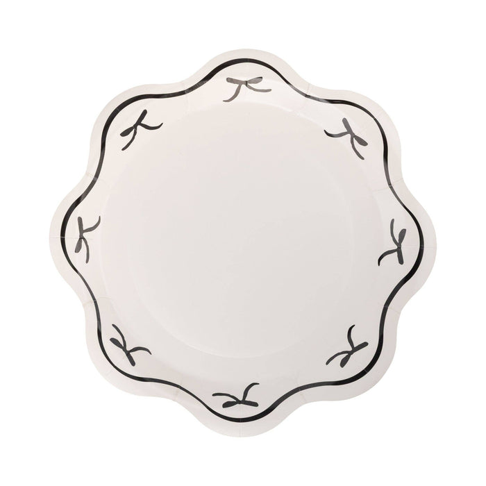 Black bow scalloped paper plate with black border on white background