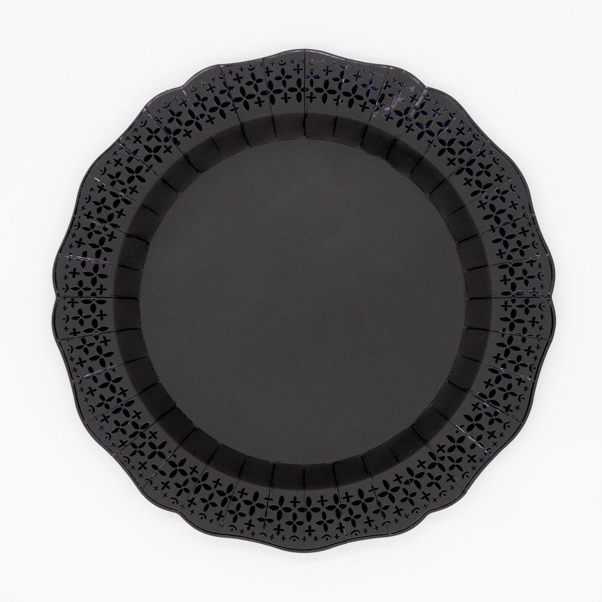 Top-down studio shot of a solid black paper dinner plate with an intricate die-cut lace scalloped border on a white background.