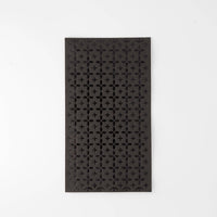 Black paper guest towel with a tone-on-tone black foil cross/plus geometric pattern, flat view on white background.