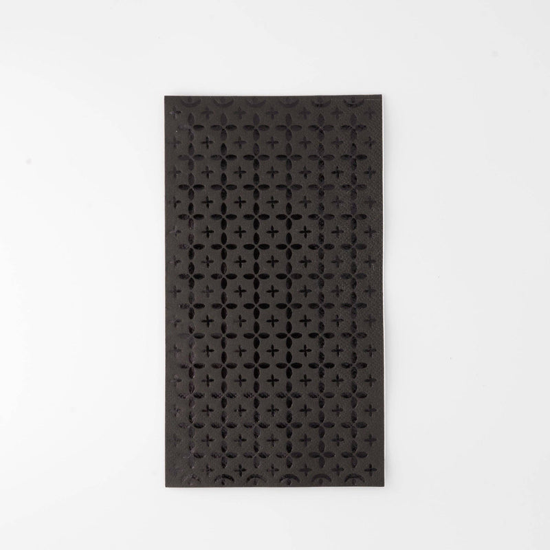 Black paper guest towel with a tone-on-tone black foil cross/plus geometric pattern, flat view on white background.