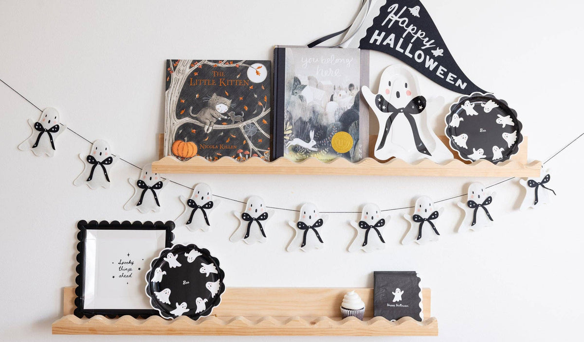 Halloween-themed decor featuring the Halloween black ghost paper napkin and other decorations. 