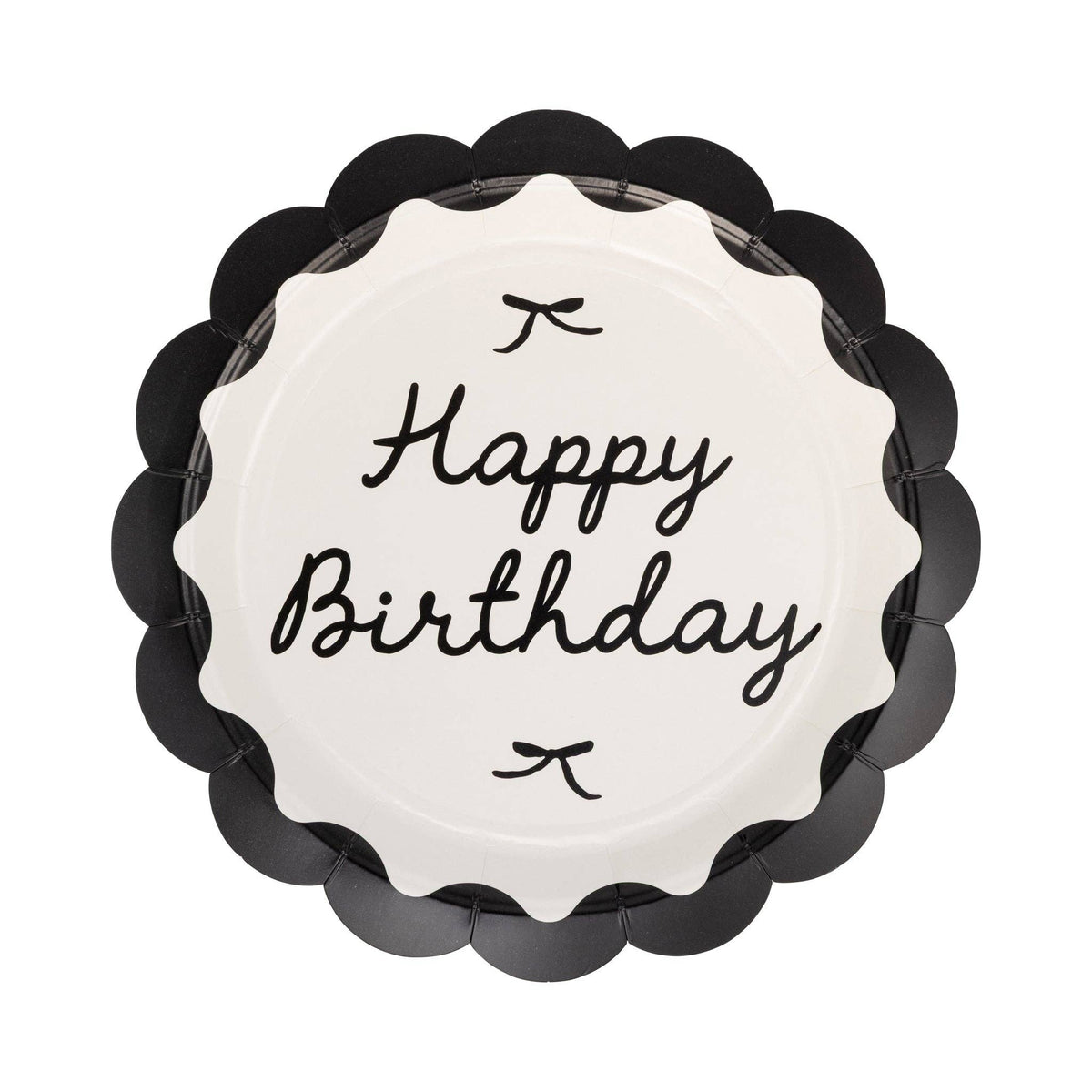 Single round black scalloped paper dinner plate with cream center Happy Birthday cursive script and small bow details on white background