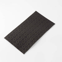 Another angle of the black foil guest towel folded, showing the premium paper weight.