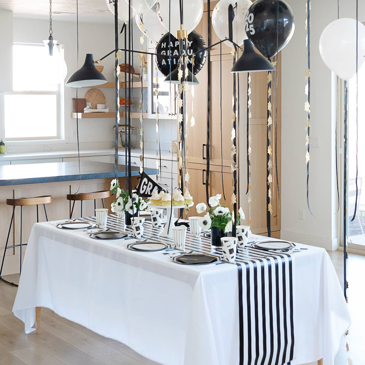 Black and white graduation party table decorated with plates and napkins
