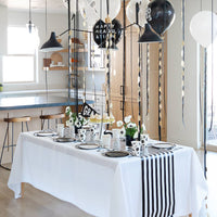 Black and white graduation party table decorated with plates and napkins