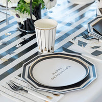 Graduation table setting with black and white decagon plate and party decorations