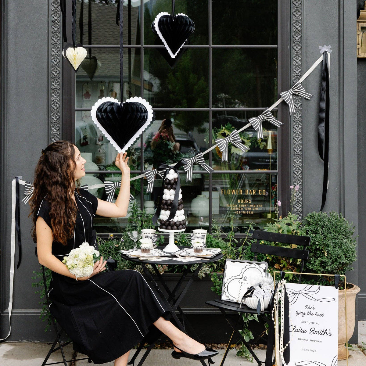 Black and white honeycomb hearts displayed with Valentine’s party decorations