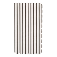 Single rectangular black and white thin striped paper guest towel with scalloped edges on white background