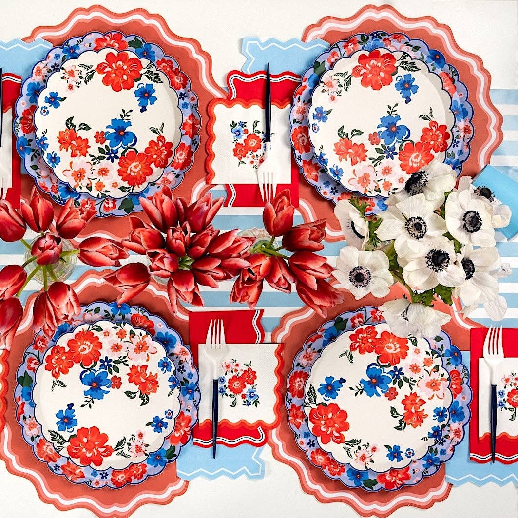 Full table setting showing the 10.5 inch Scalloped Paper Plates mixed with floral and striped motifs.