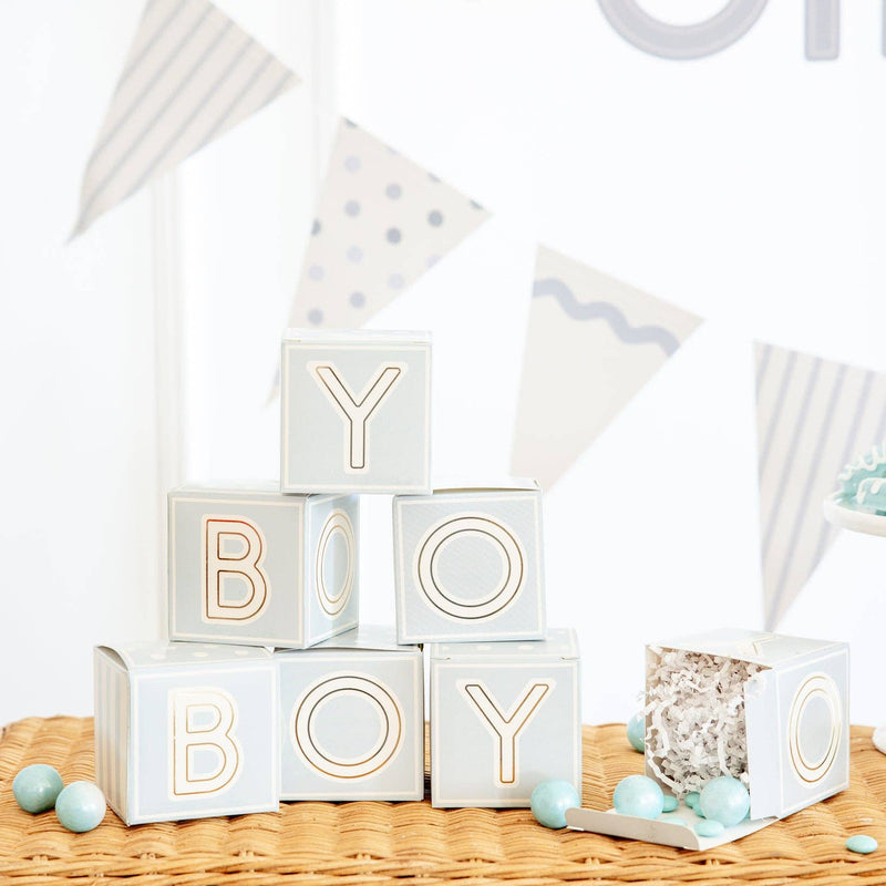 Blue baby block treat boxes stacked spelling BOY on wicker table