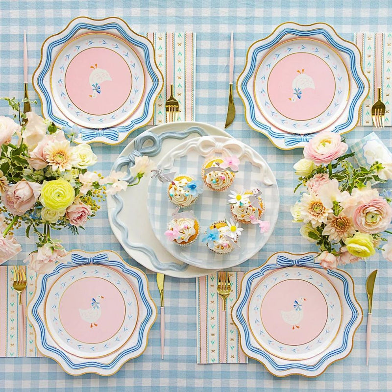 Spring table setting with blue bow plates and pastel decorations