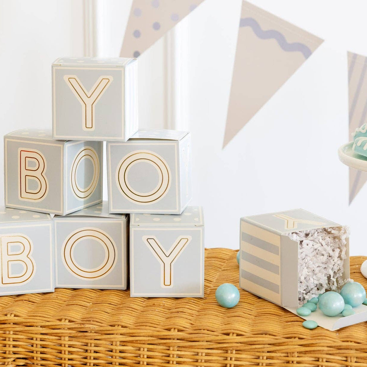 Close-up of stacked blue baby block boxes spelling BOY