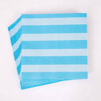 Stack of folded blue and white striped paper lunch napkins