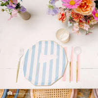 Blue cabana stripe paper plate place setting with pink striped napkin, gold flatware, and pennant cake topper photographed by Jessica Lynn Photo for Beijos Events