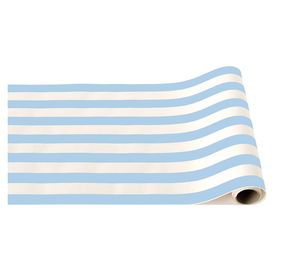 Sky blue and cream cabana stripe paper table runner partially unrolled on a white background