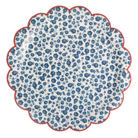 Single blue ditsy floral scalloped paper plate showing indigo floral pattern on cream base with red scalloped rim on white background