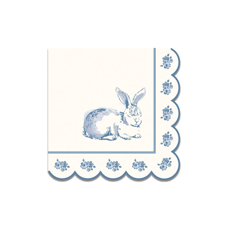 A stack of blue and white doily-patterned cocktail napkins with scalloped edges, perfect for a Peter Rabbit aesthetic party.